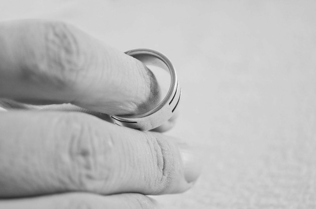 Zoom in photo of a hand holding a ring.