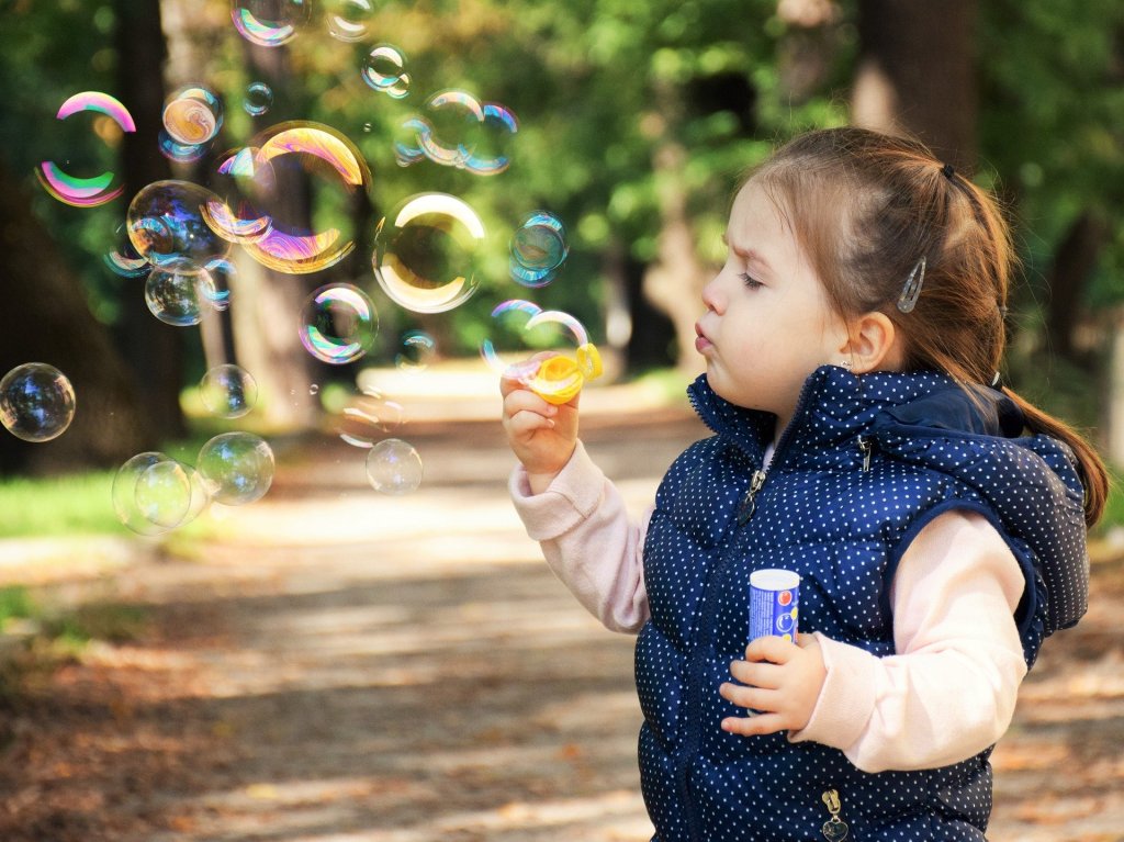 A child blowing bubbles.