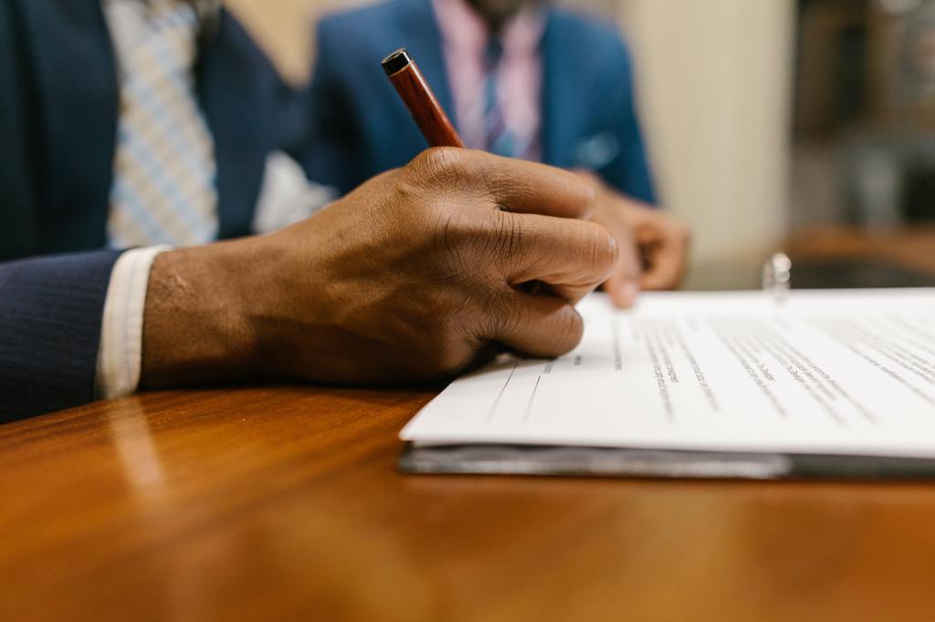 A person signing paper work.