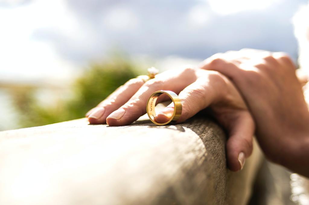 A person holding a wedding ring.