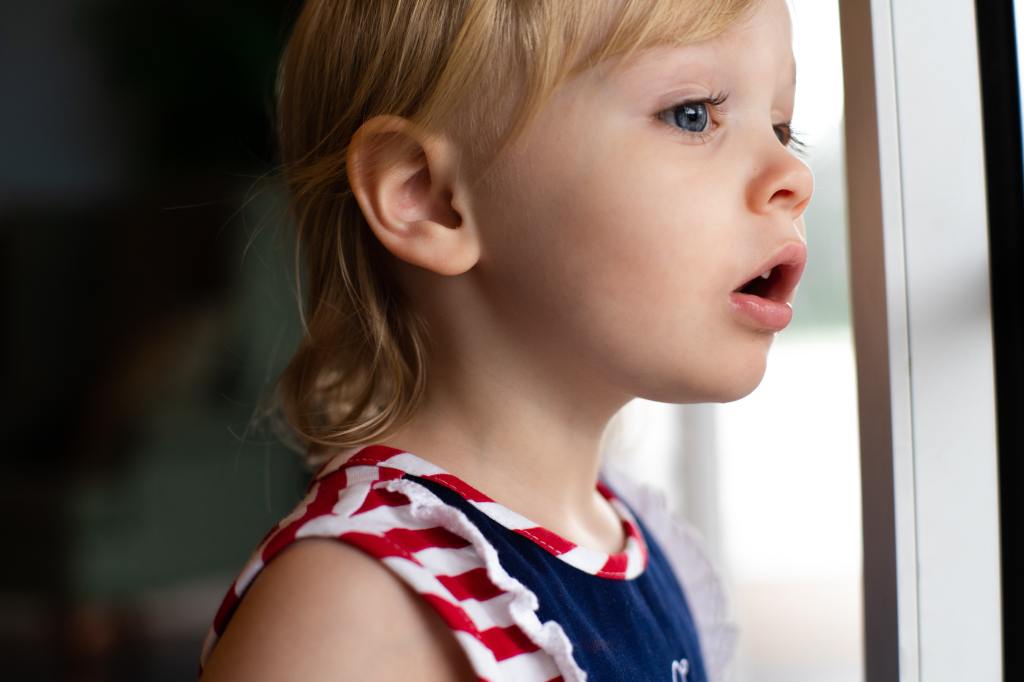 A child looking out a window.