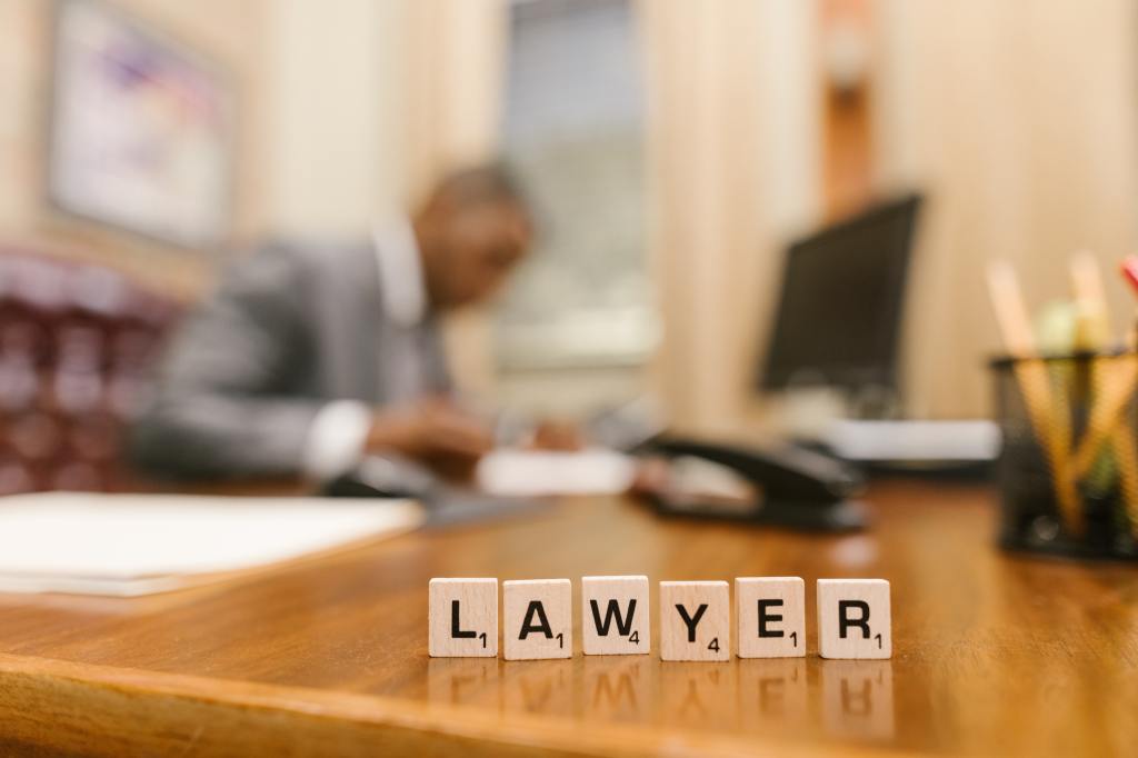 Scrabble tiles that spell out "lawyer."