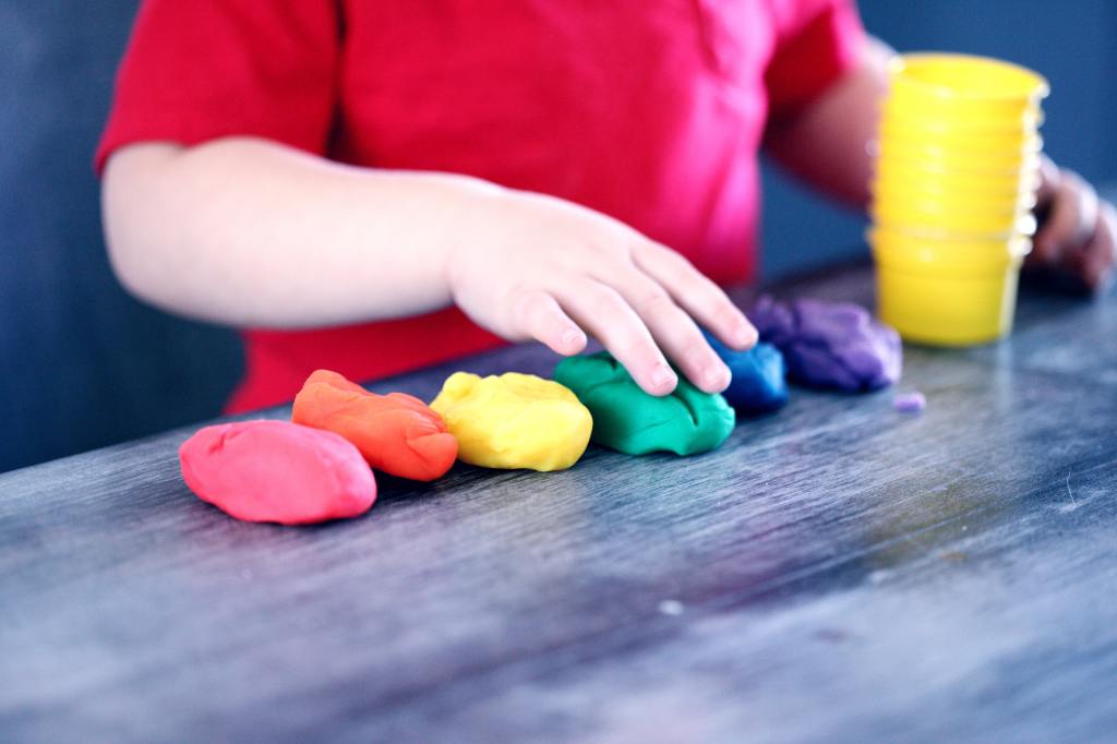 A child playing with playdough.